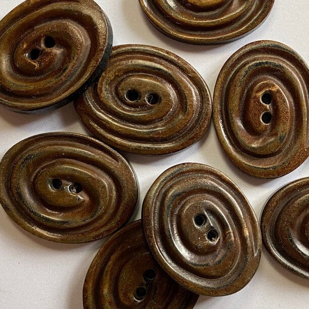 Brown spiral buttons on a white background