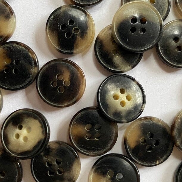Collection of brown buttons on a white background