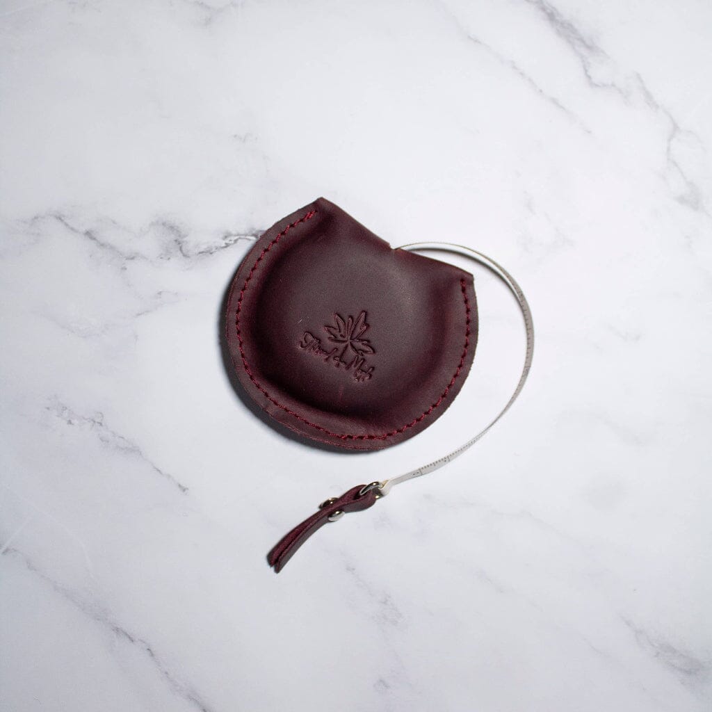 Thread & Maple leather tape measure in Wine, showing the retractable tape