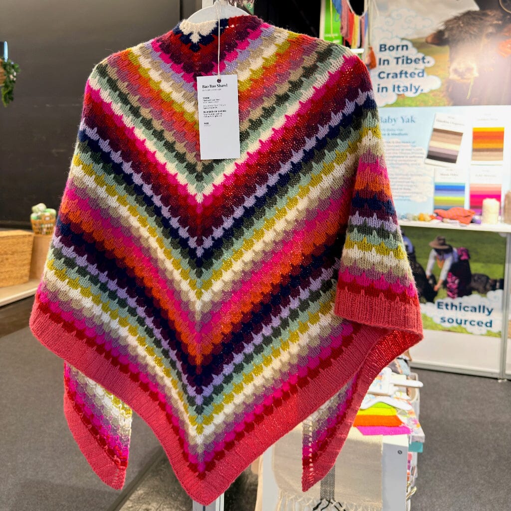 Colorful striped shawl on a stand with a blurred background