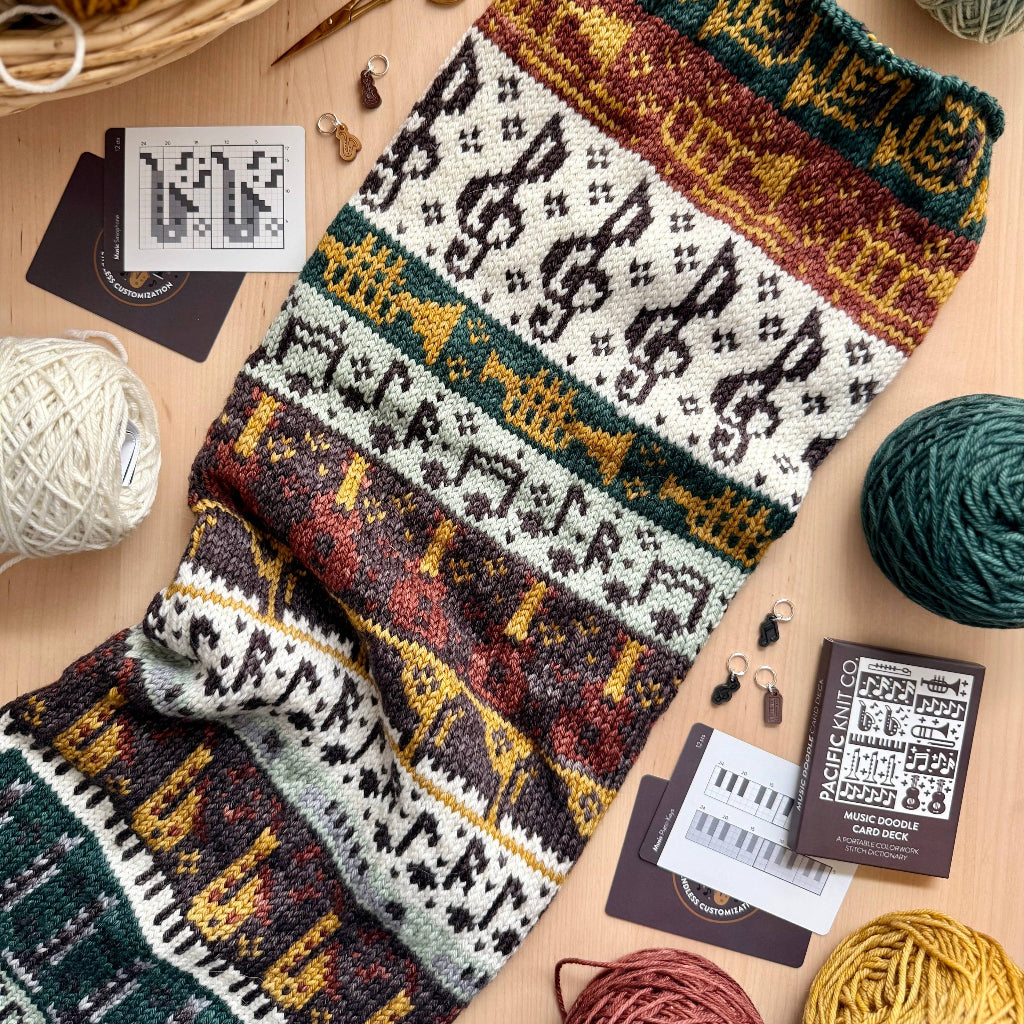 Knitted pattern with yarn and knitting tools on a wooden surface