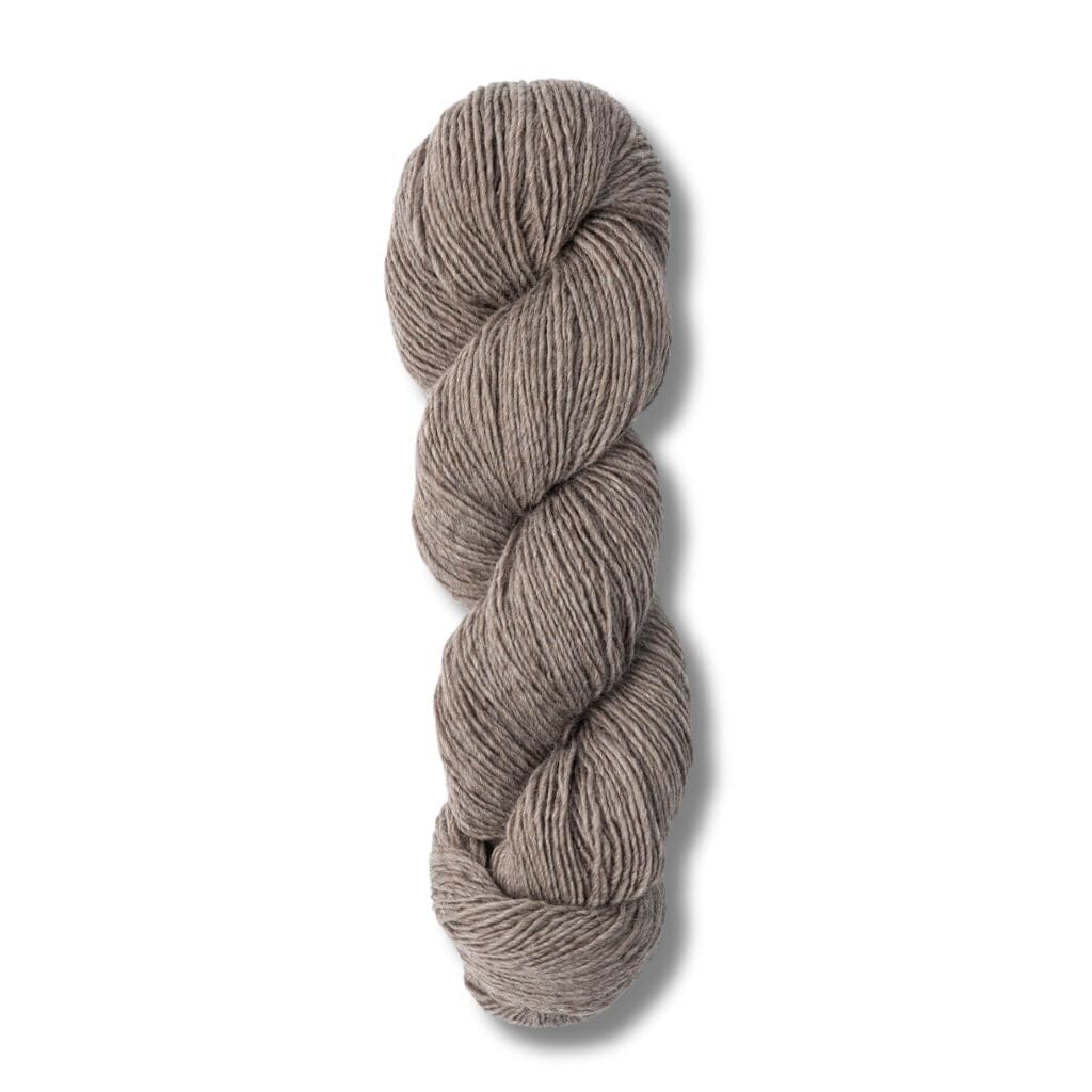 skein of Blue Sky Fibers Woolstok Light yarn in gravel road