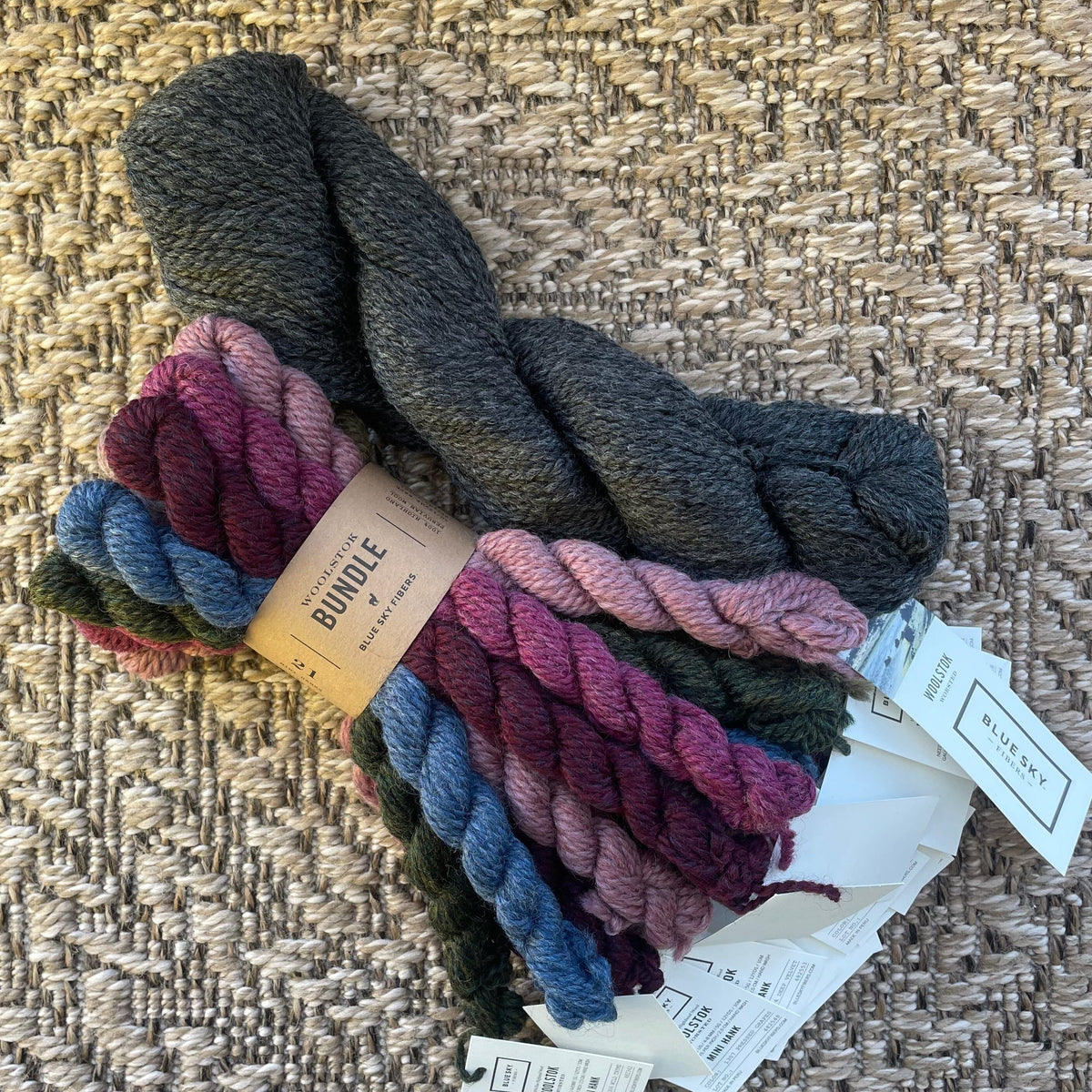 Bundle of multicolored yarn with tags on a textured surface