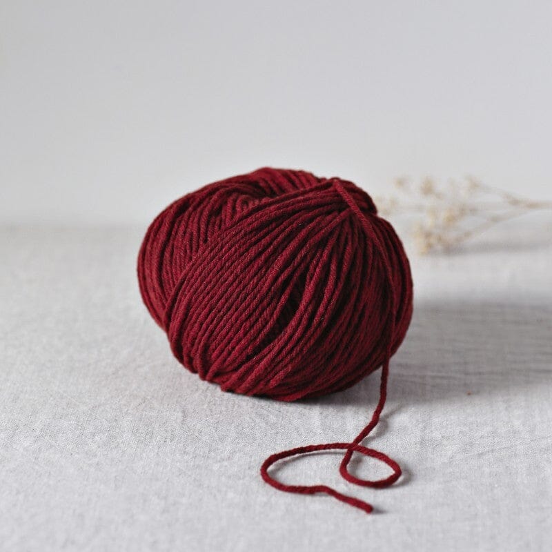 Red skein of yarn on a white background