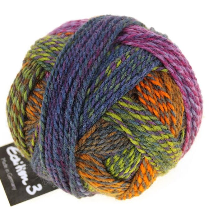 Multicoloured skein of yarn with a label on a white background