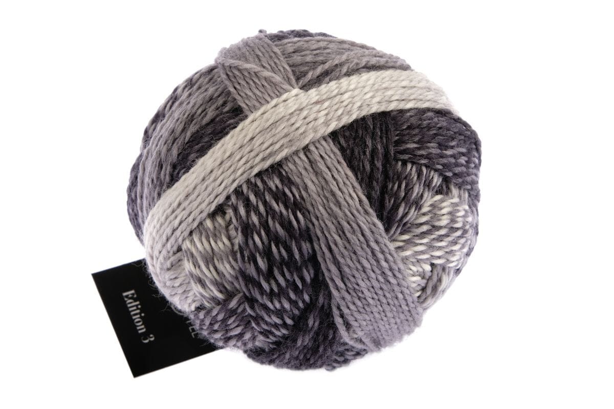 Gray skein of yarn with a black label on a white background