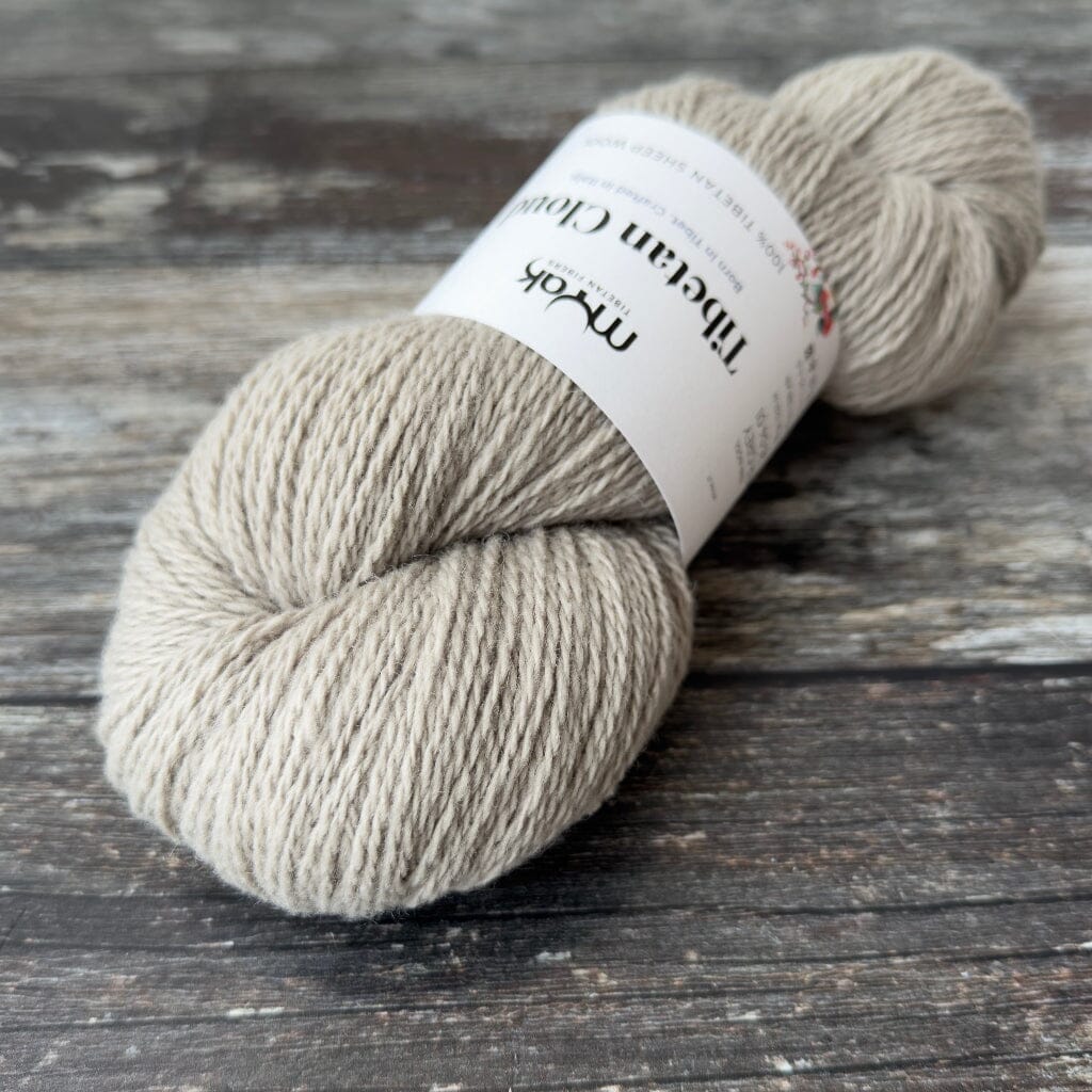 Ball of yarn with a label on a wooden surface