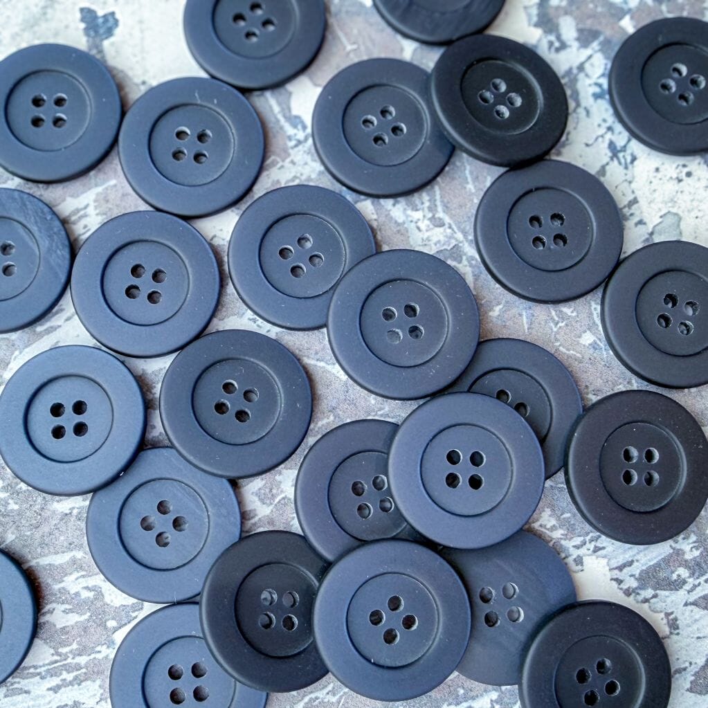 navy four hole buttons on a textured background