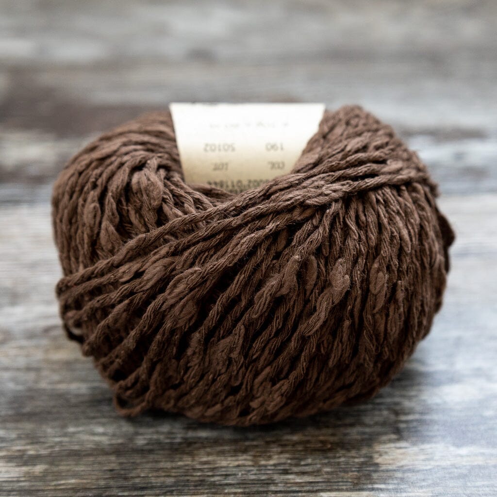 Brown yarn ball on a wooden surface