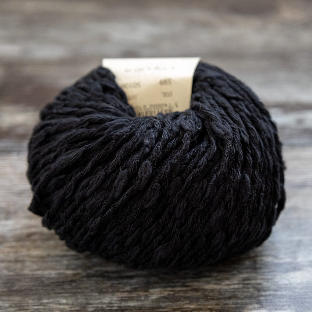 Black yarn ball on a wooden surface