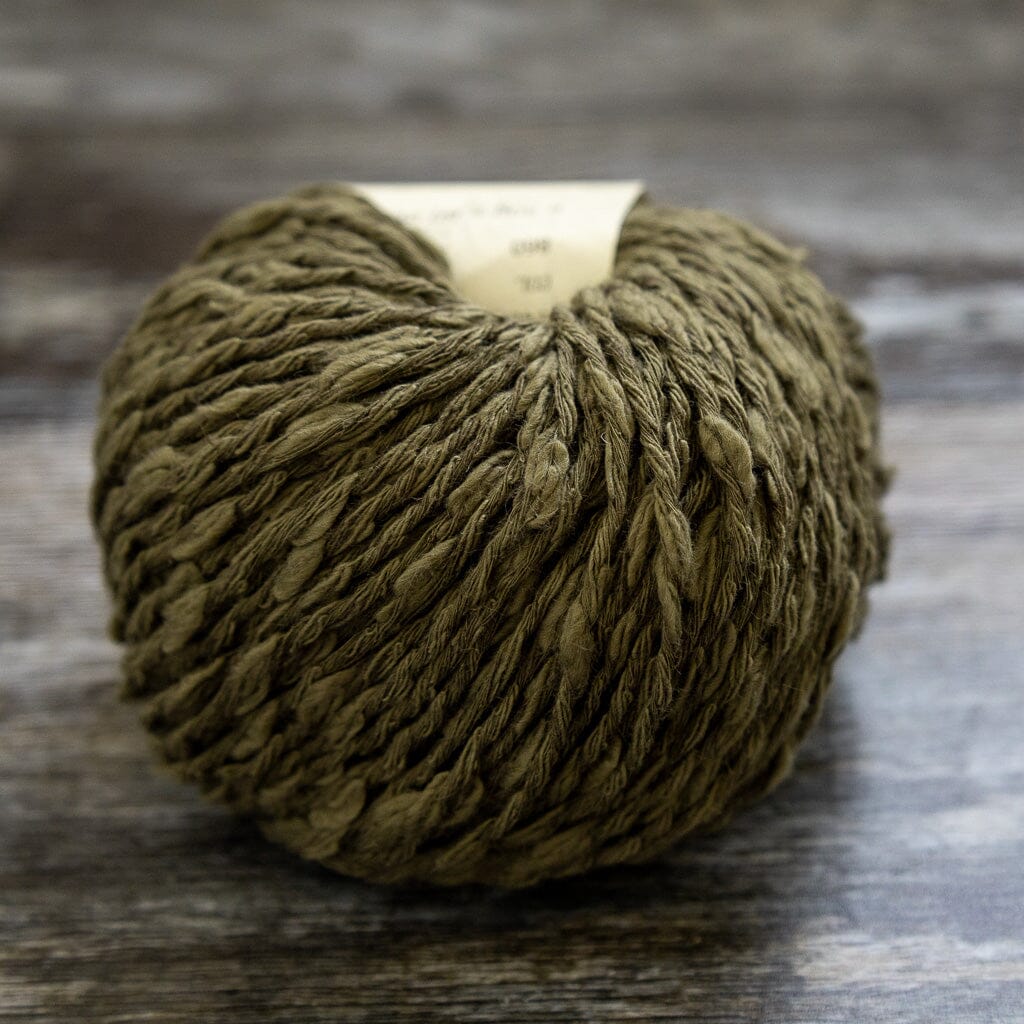Ball of green yarn on a wooden surface