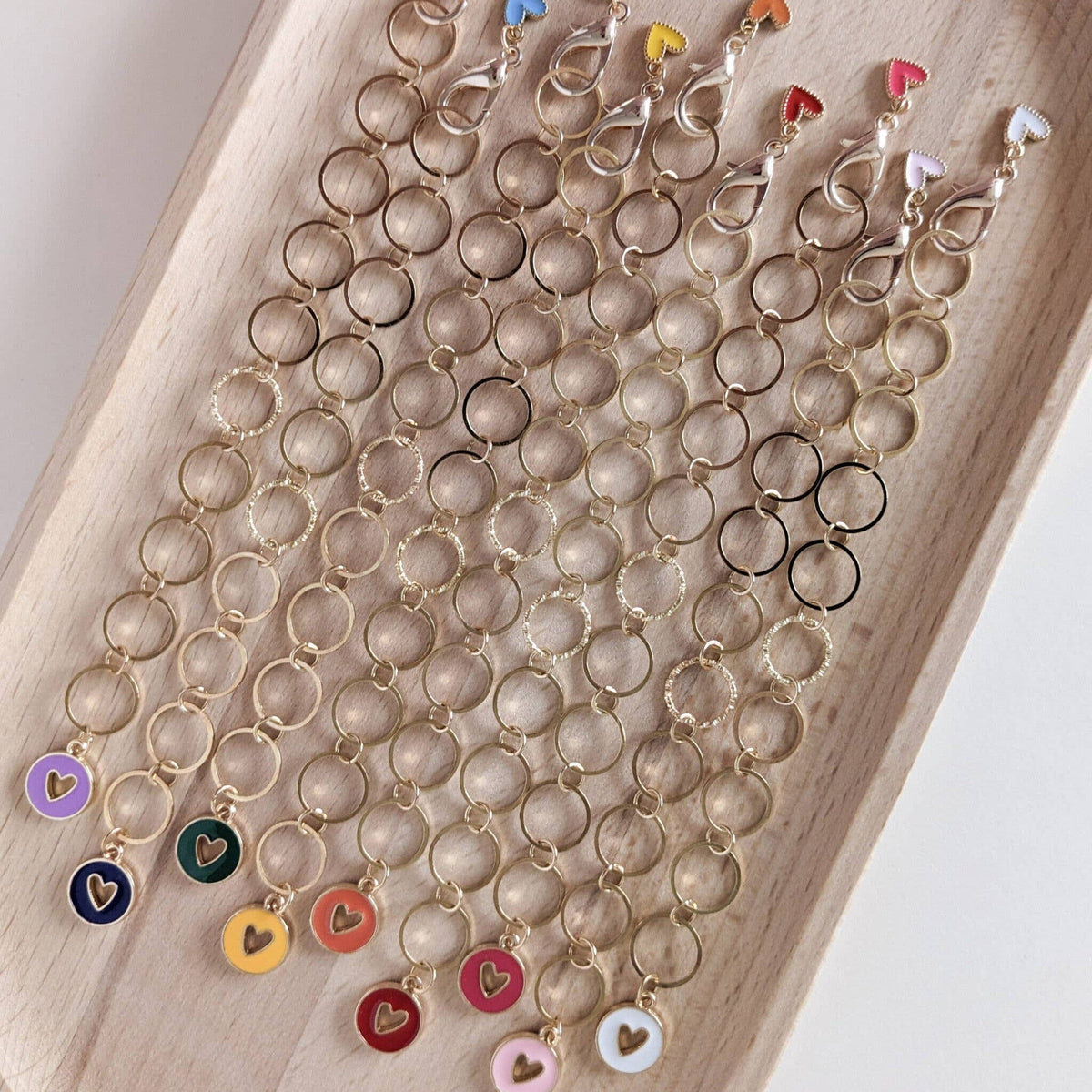 Colourful heart charms on a wooden tray