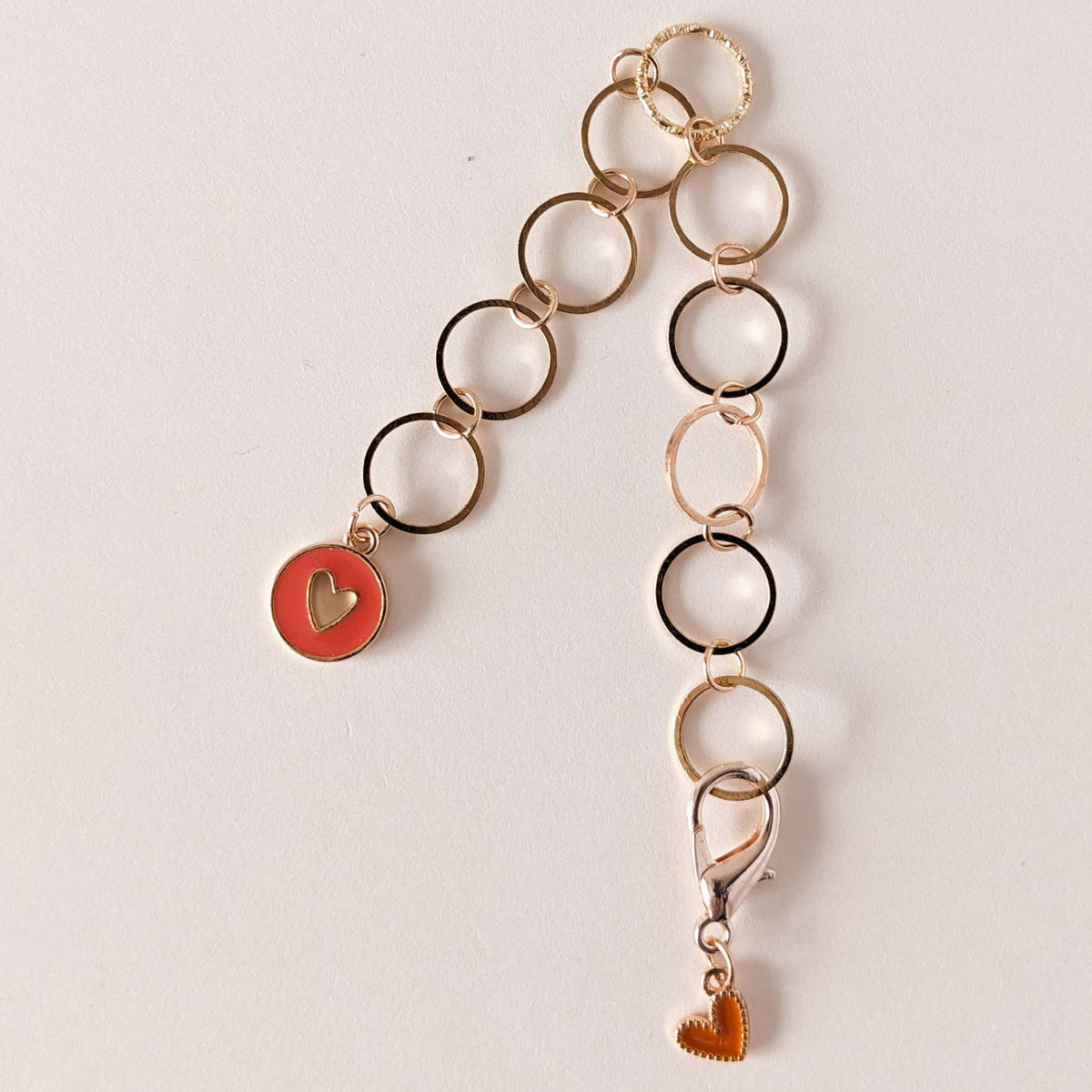 Long row counter chain with heart-shaped charms on a light background