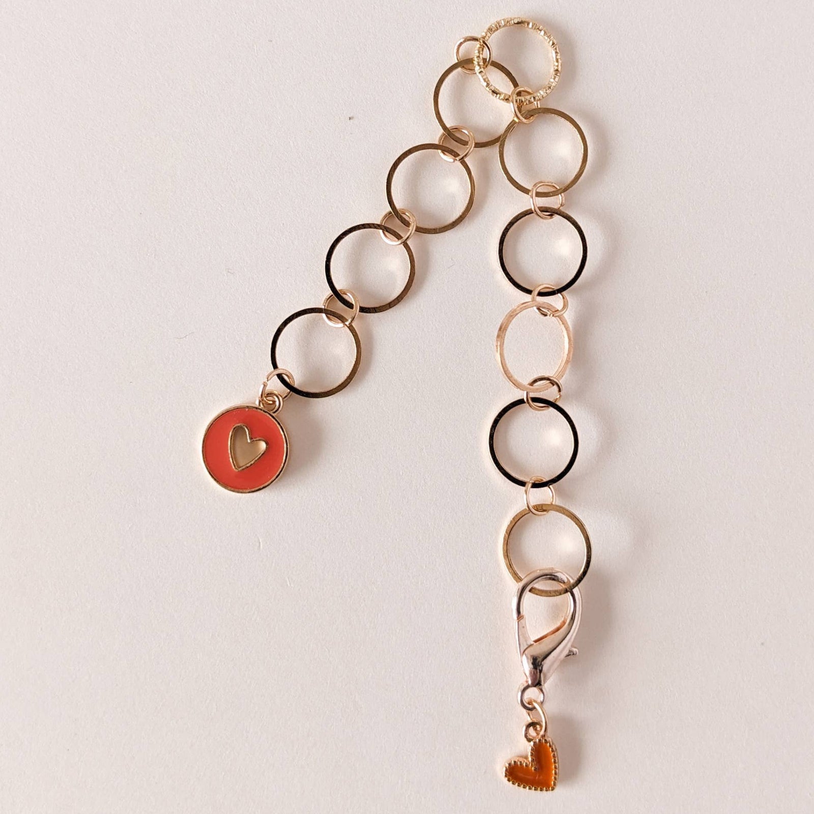 Long row counter chain with heart-shaped charms on a light background