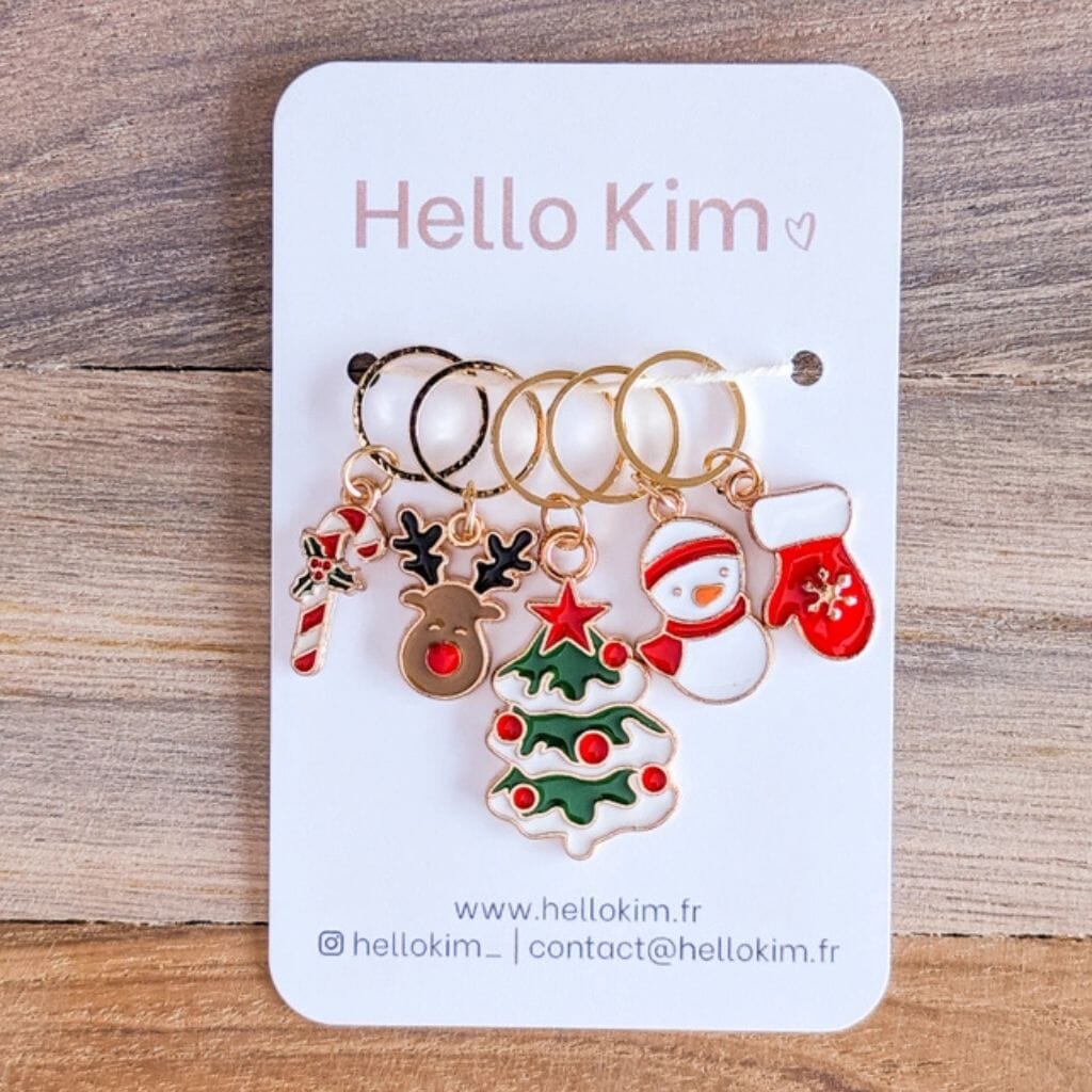 Set of Christmas-themed stitch markers on a 'Hello Kim' branded card.