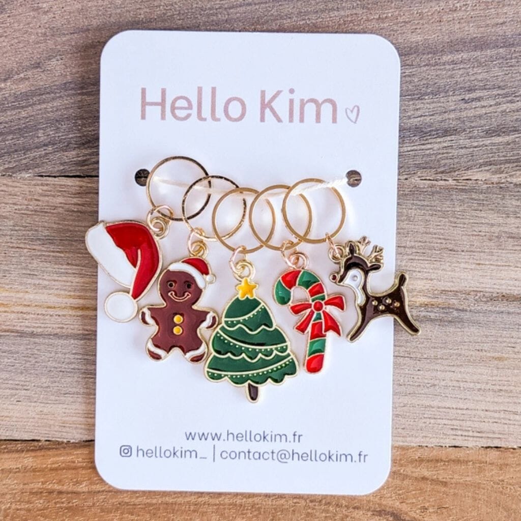 Set of Christmas-themed knitting stitch markers on a &#39;Hello Kim&#39; branded card.
