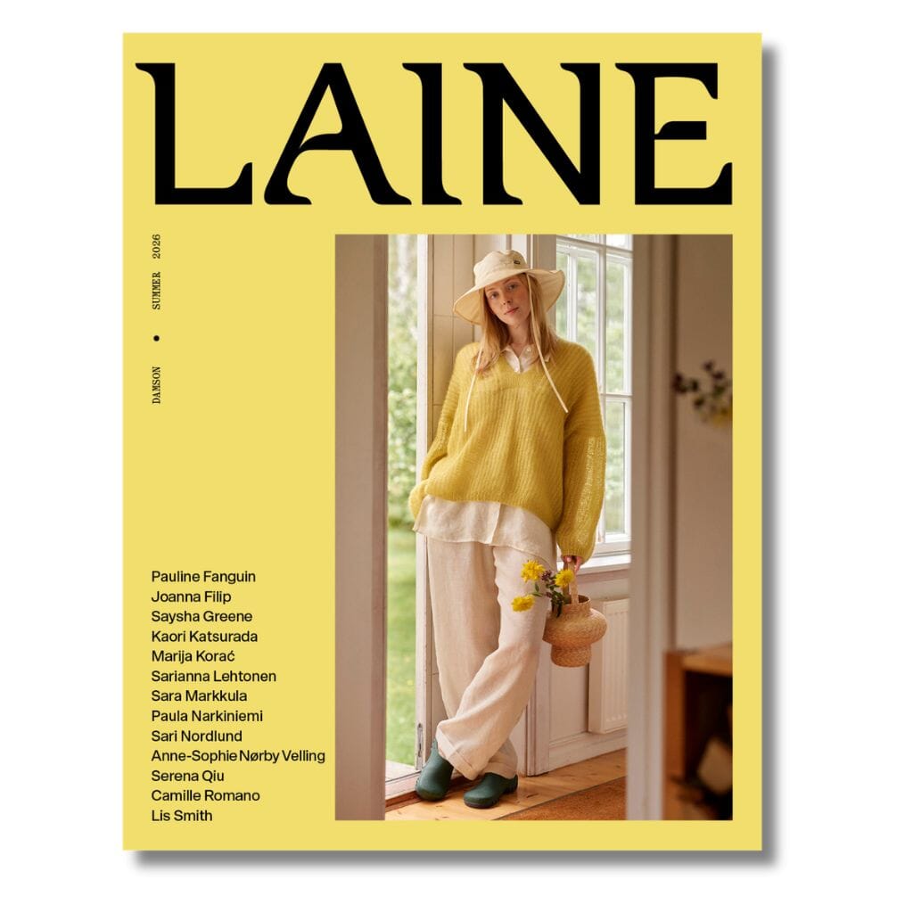 Magazine cover with a person in a yellow sweater and white pants, holding flowers, on a yellow background with 'Laine' branding.