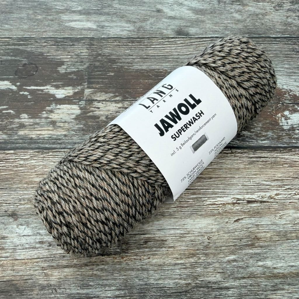 Marled Ball of yarn with a label on a wooden surface