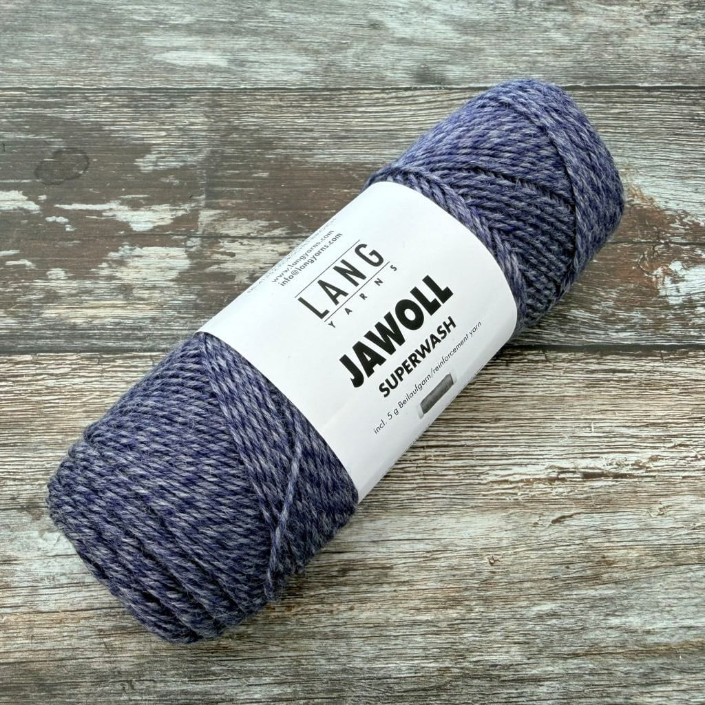 Blue marled Ball of yarn with a label on a wooden surface
