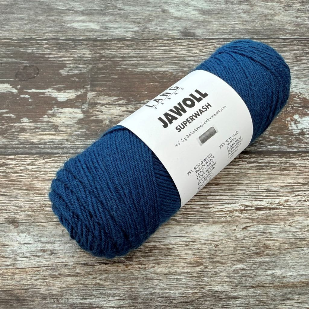 Blue ball of yarn with a label on a wooden surface