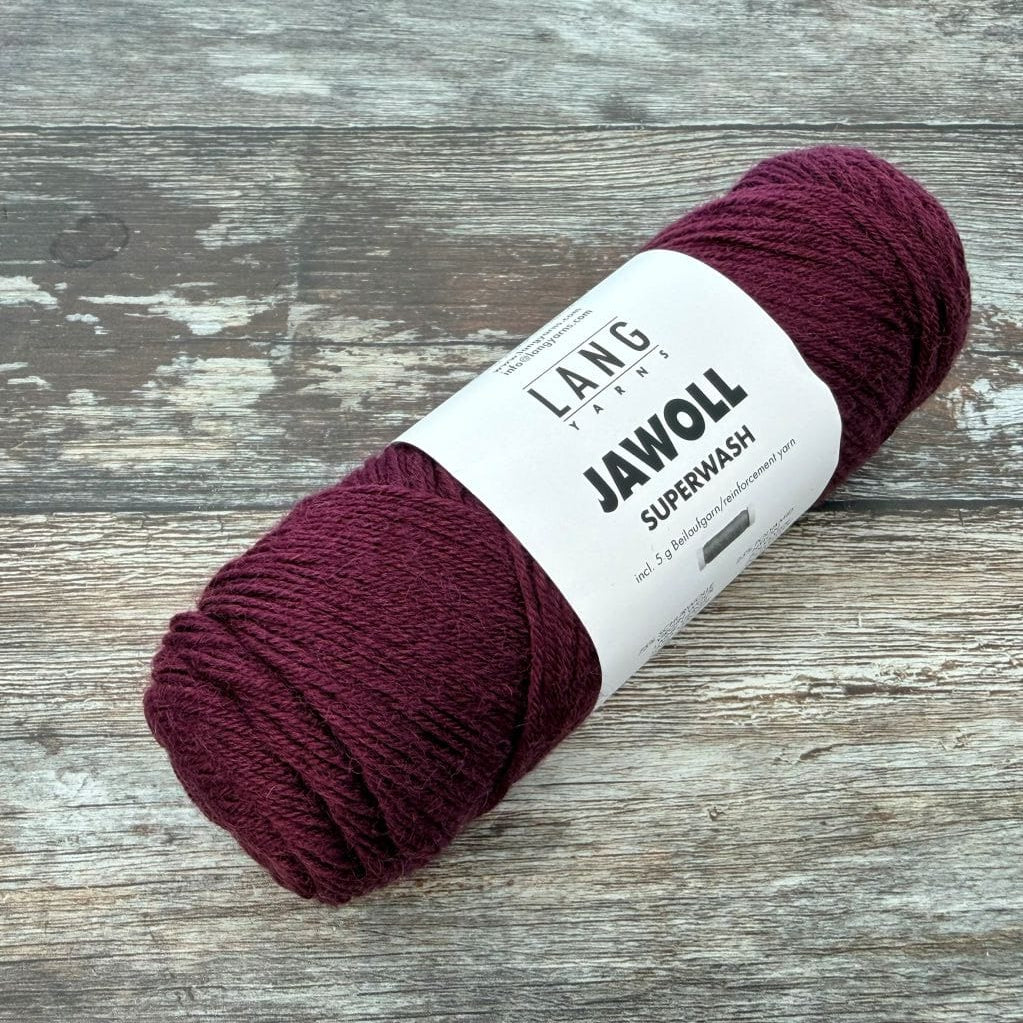 plum Ball of yarn with a label on a wooden surface