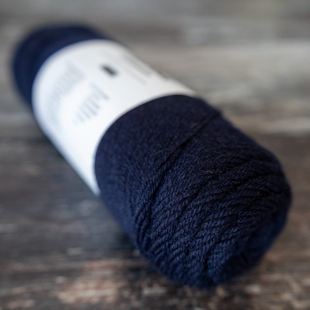 Blue sock yarn on a wooden surface