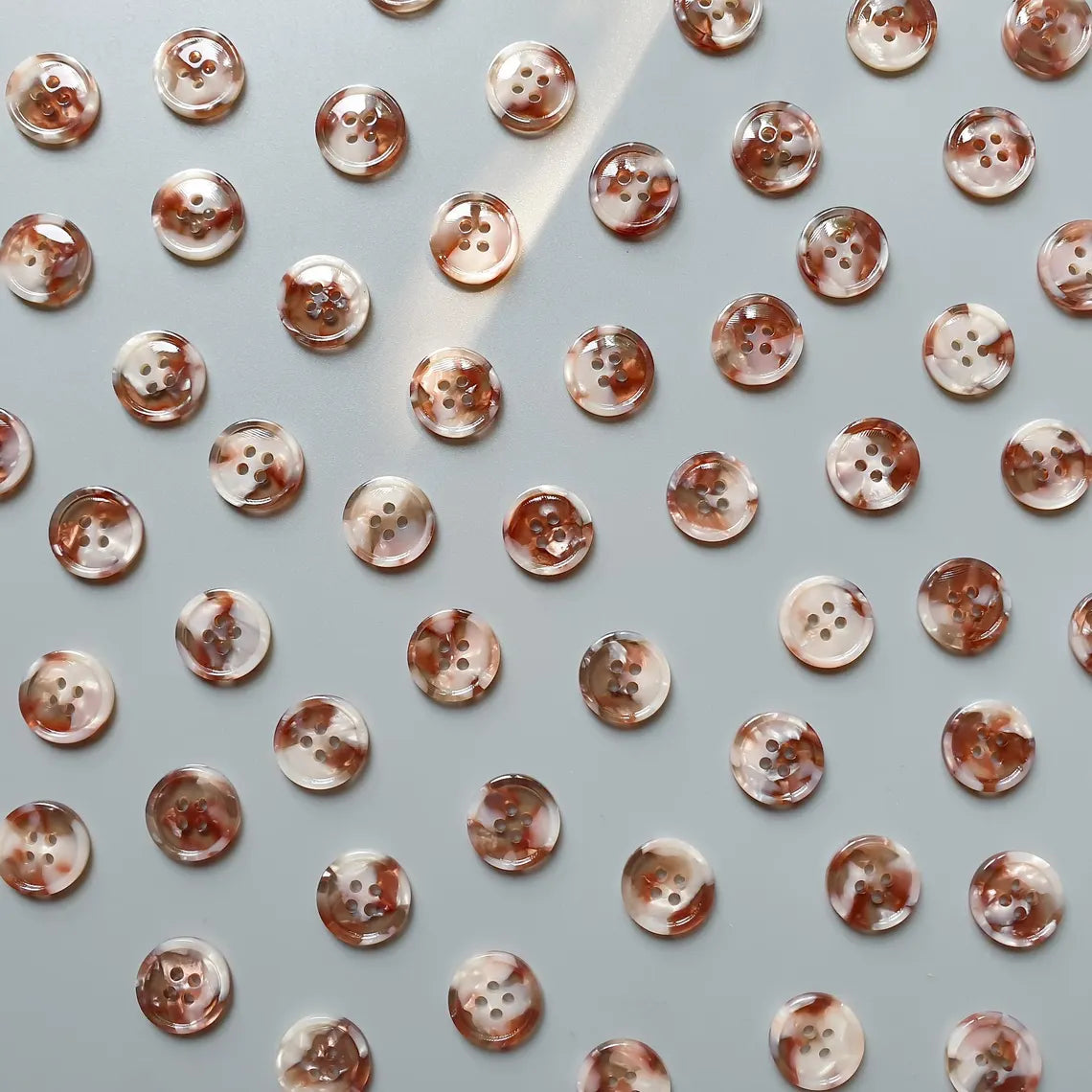 Pattern of small buttons on a light gray background