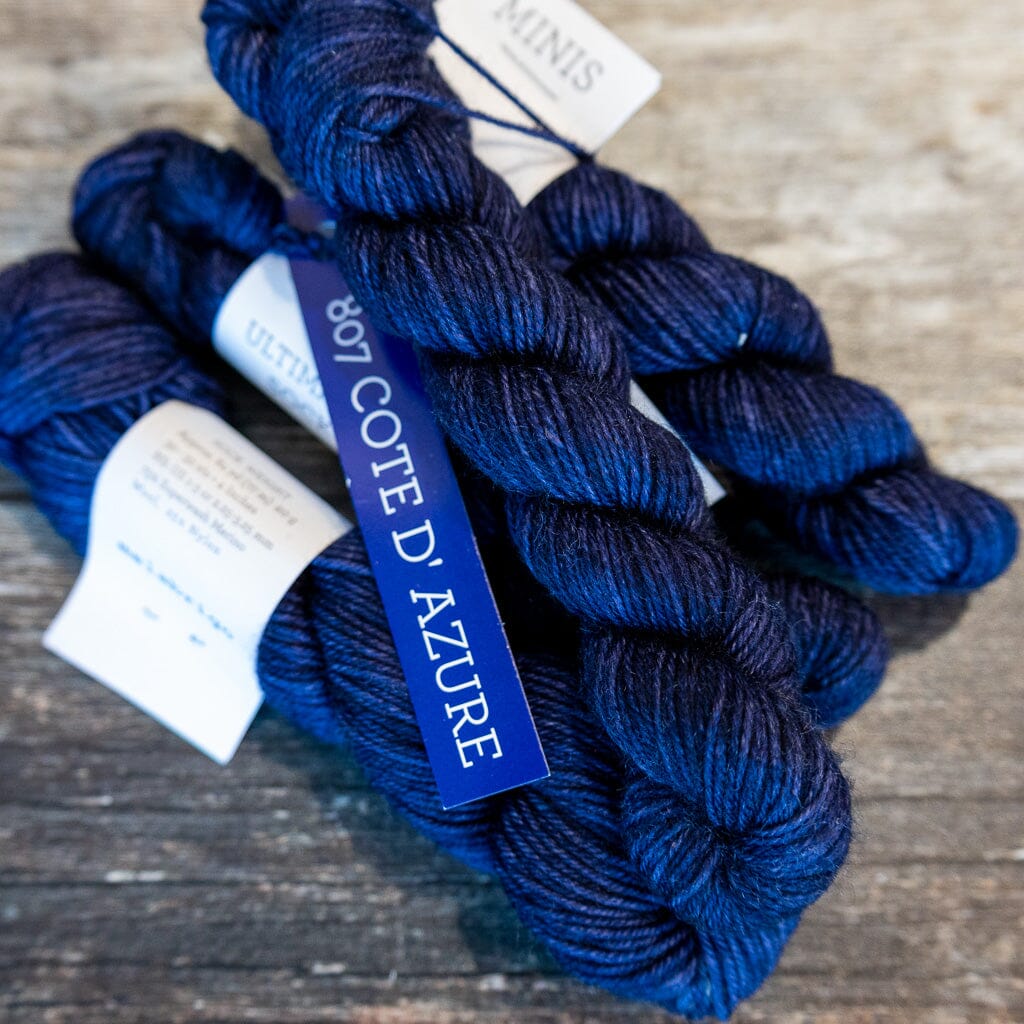 Blue yarn skeins with 'Cote d'Azur' label on a wooden surface