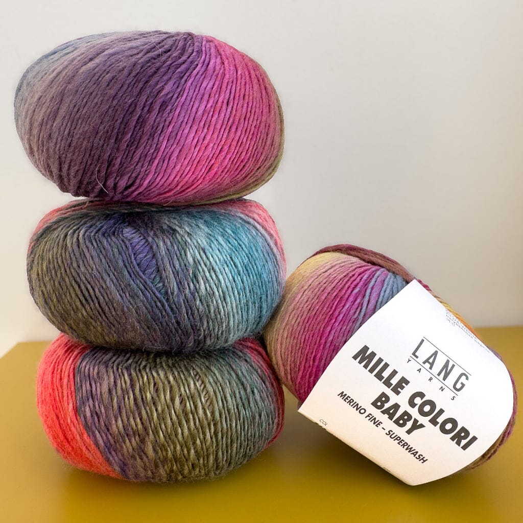 Four skeins of multicoloured yarn from lang yarns with a label on a yellow surface 
