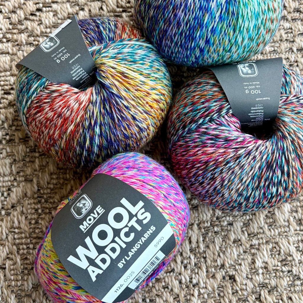 4 balls of multicoloured yarn on woven carpet