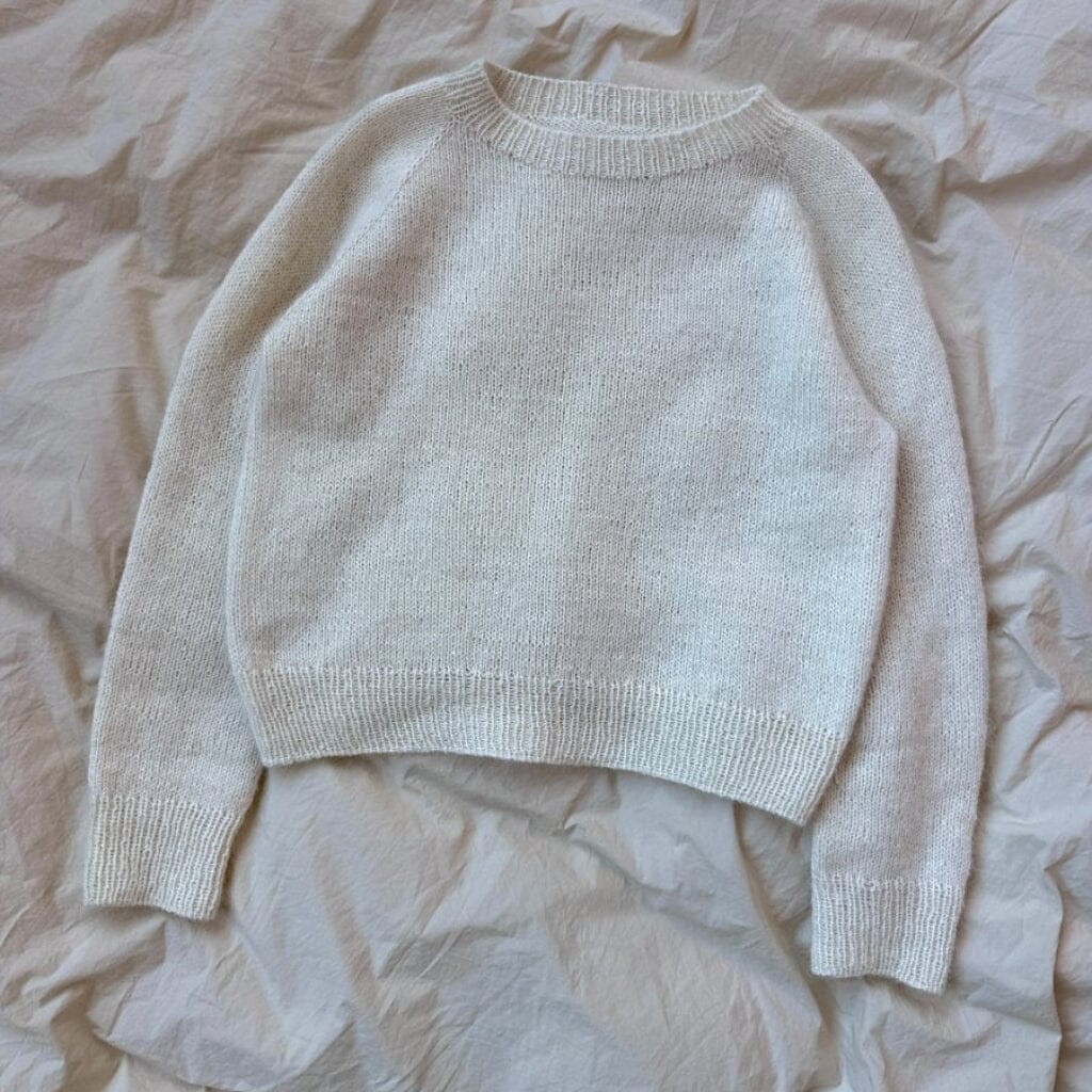 Beige sweater on a beige textured surface