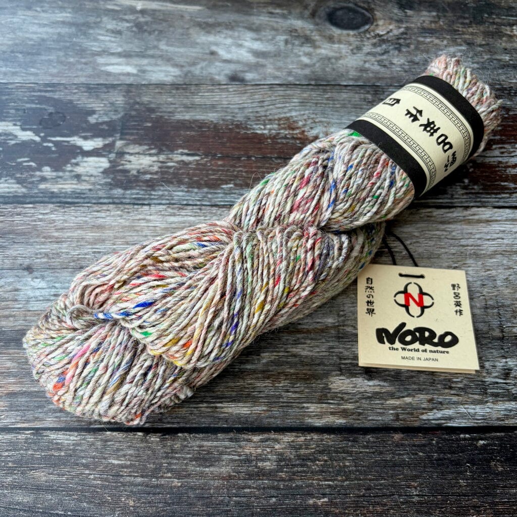 skein  of multicolored yarn with a Noro label on a wooden surface