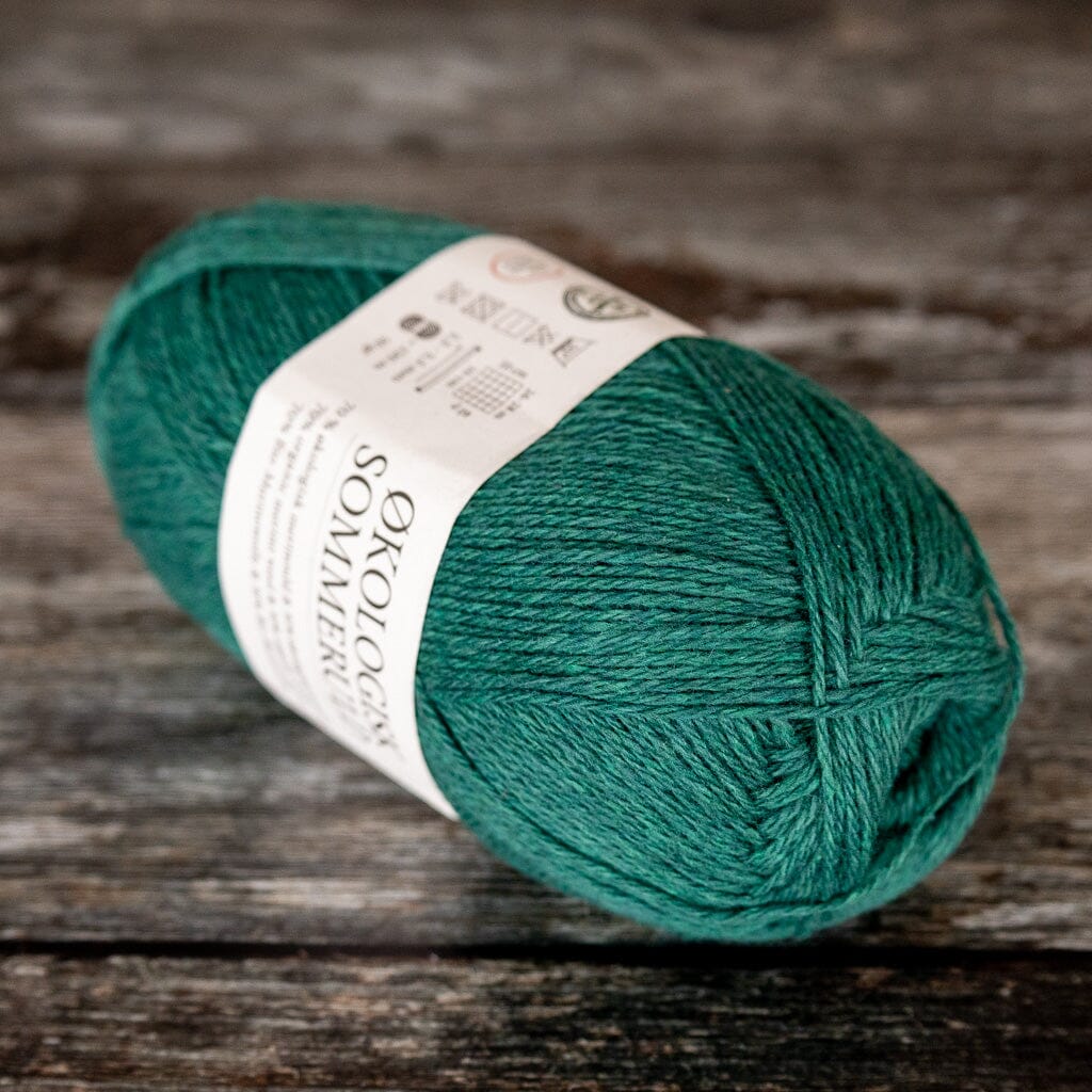 ball of green yarn, a blend of merino wool and cotton.