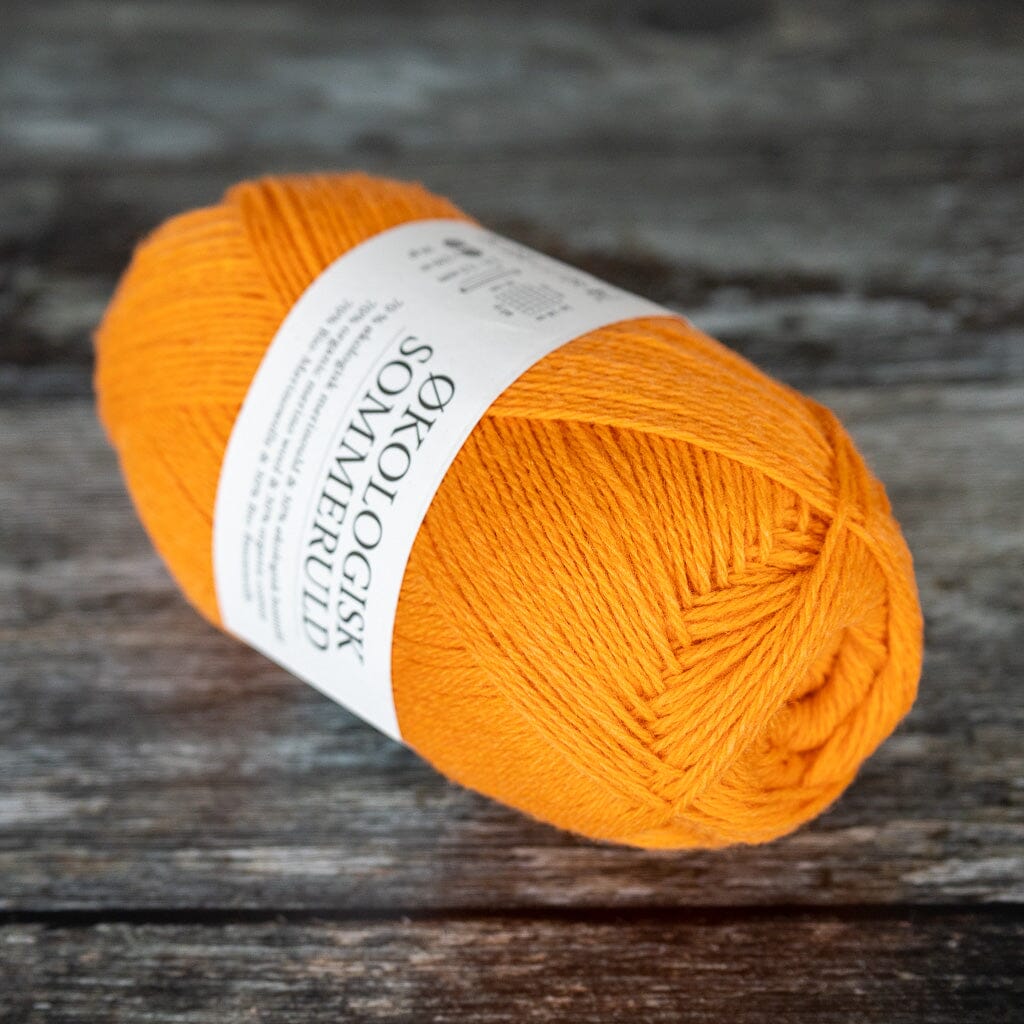 ball of orange yarn, a blend of merino wool and cotton.