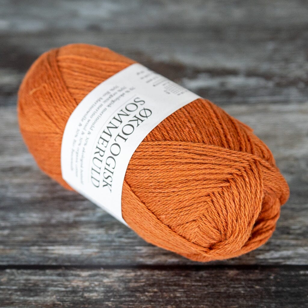 ball of orange yarn, a blend of merino wool and cotton.
