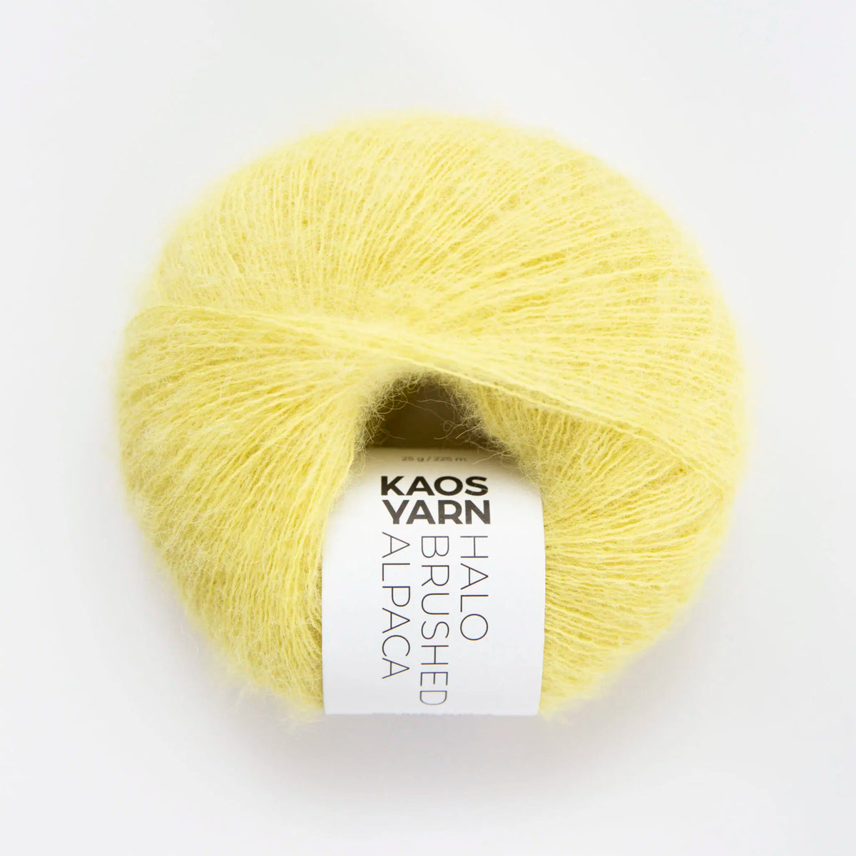 Yellow ball of alpaca yarn with a label on a white background
