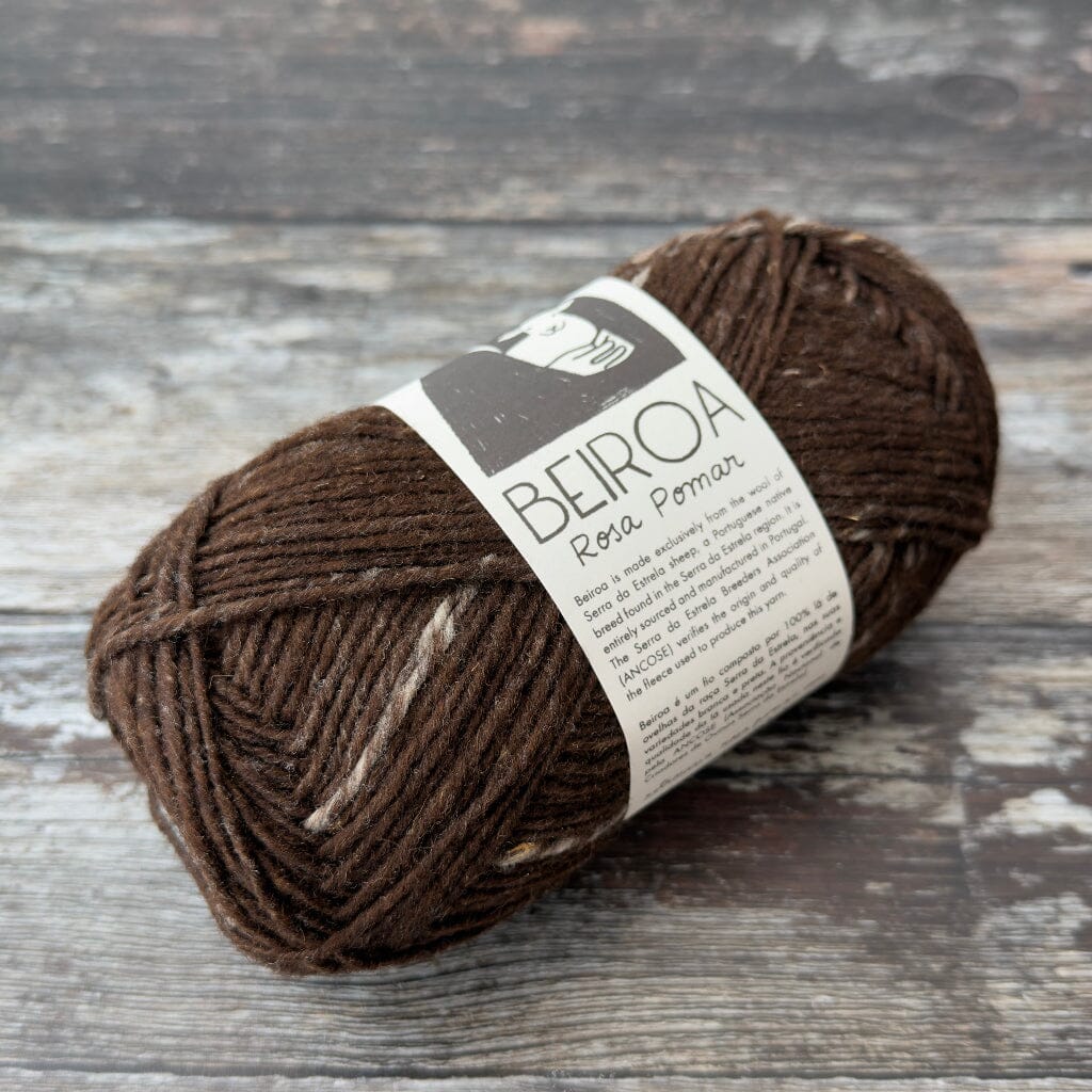 brown ball of yarn on wooden surface with label beiroa