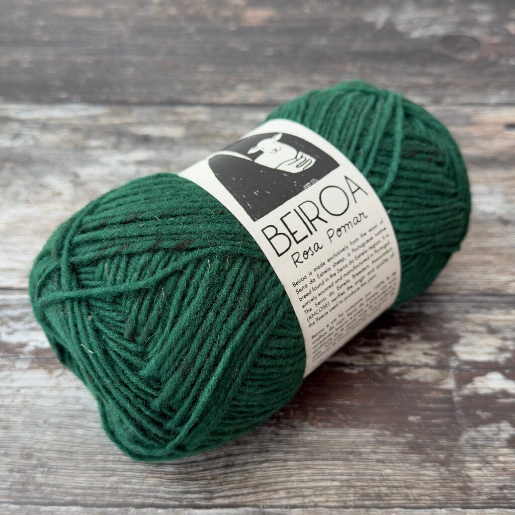 green ball of yarn on wooden surface with label beiroa