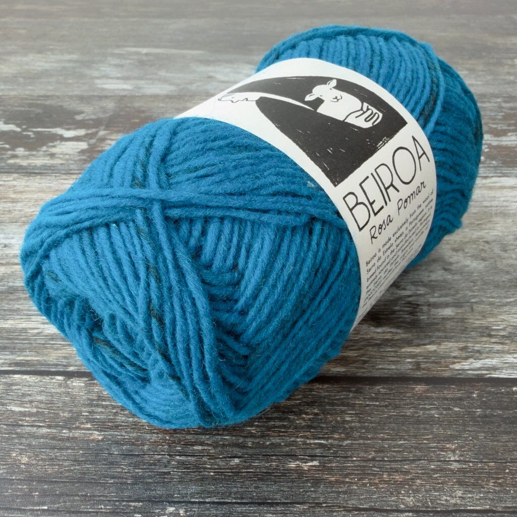 electric blue  ball of yarn on wooden surface with label beiroa