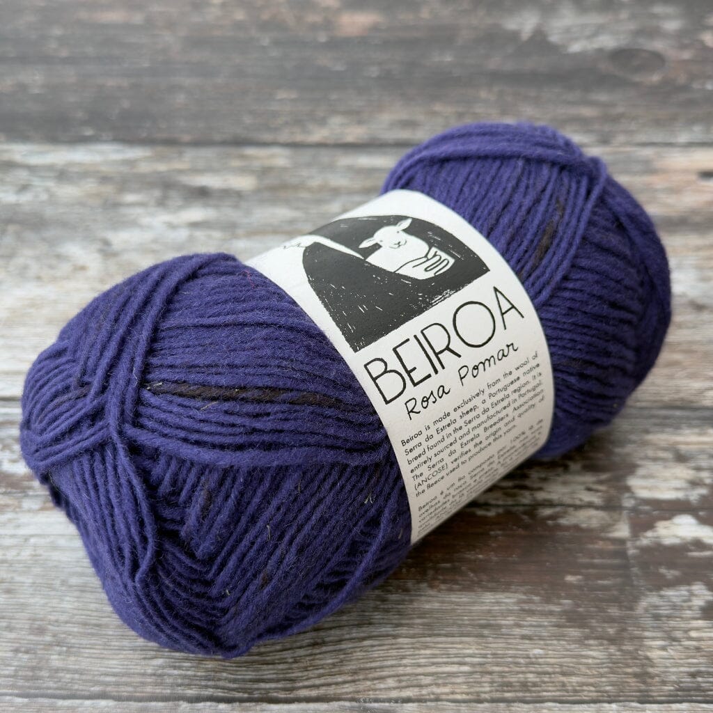 navy ball of yarn on wooden surface with label beiroa