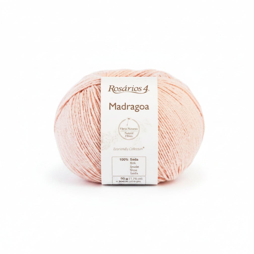 A ball of Rosarios 4 Madragoa yarn in a soft peach-pink color, featuring a white paper label with product details, set against a plain white background.