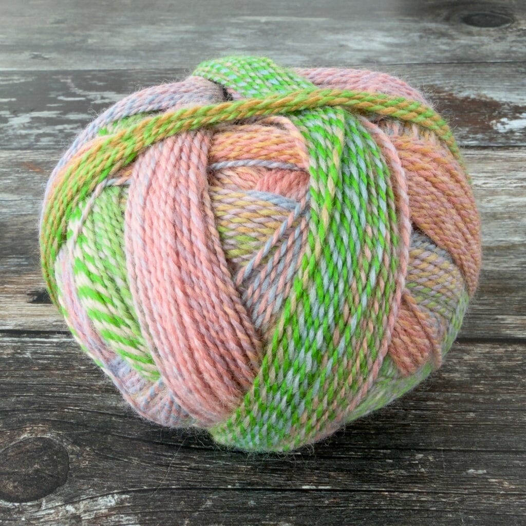 Multicolored skein of yarn on a wooden surface