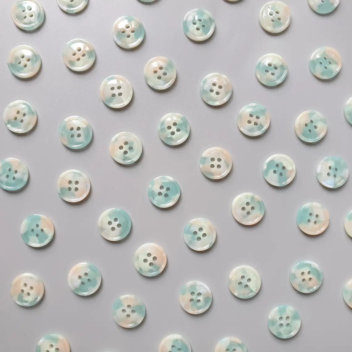 Pattern of buttons with a gradient effect on a gray background