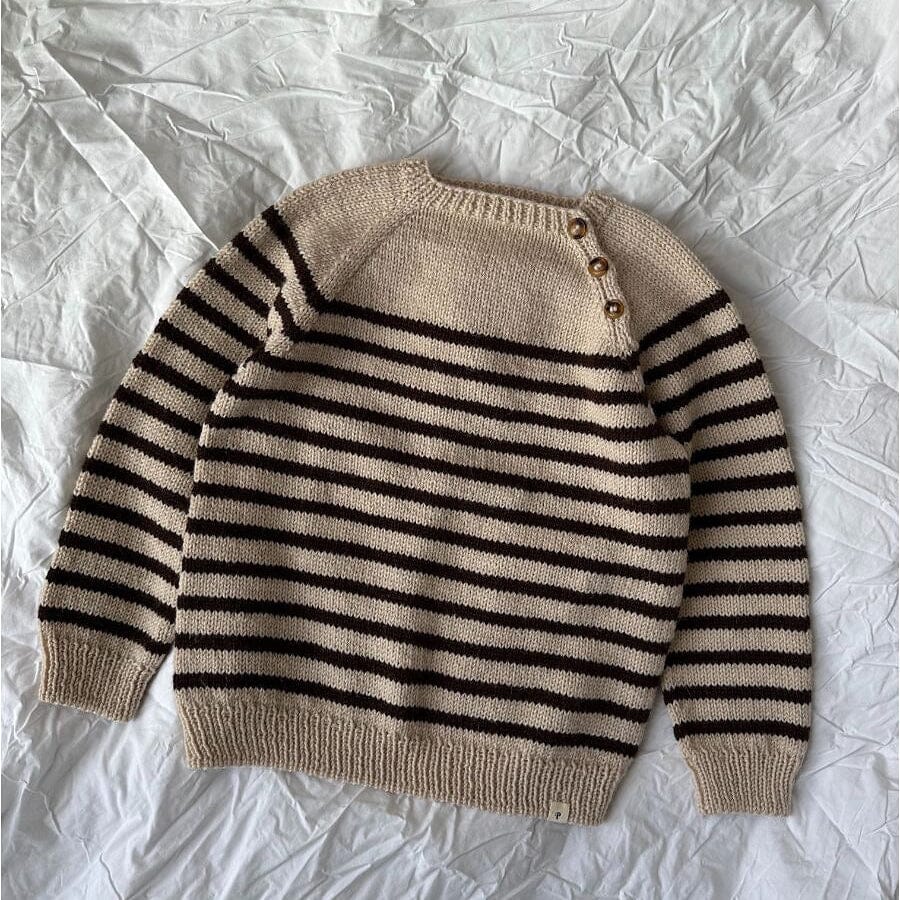 knitted stripey sweater on linen sheet