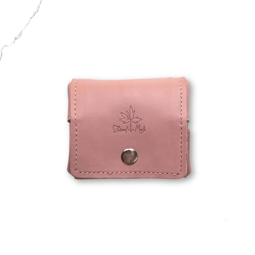 Pink wallet with a brand logo on a white background