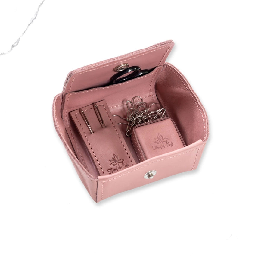 Pink notions set pouch with needles and scissors on a white background