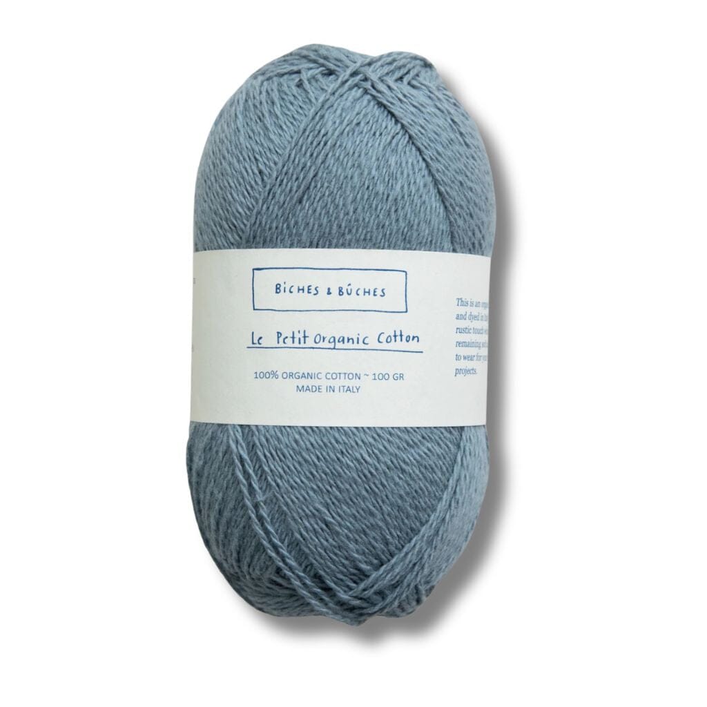 Blue ball of cotton, biches&amp;buches on label with a white background