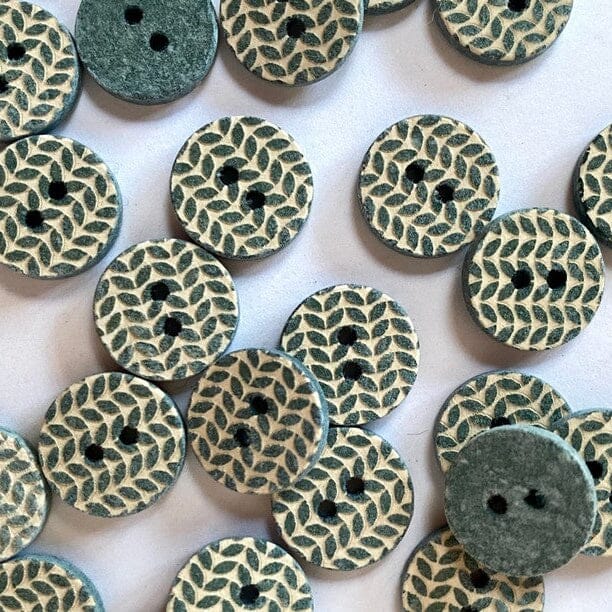 Wooden buttons with knitted pattern on a white background