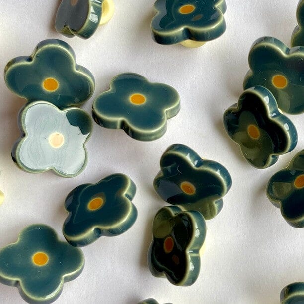 teal greenish blue flower buttons
mustard yellow centre