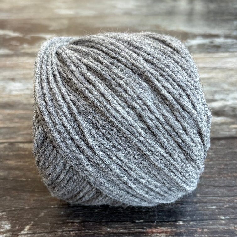 grey ball of yarn on wooden surface